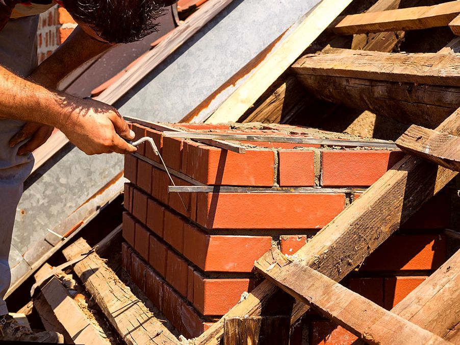 Fresh brick being bedded on an Edison chimney rebuild