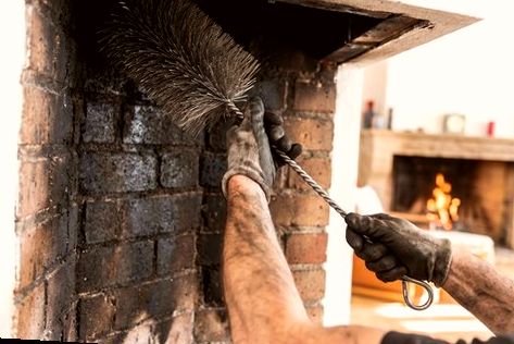 Detail brushing inside a firebox before masonry repair